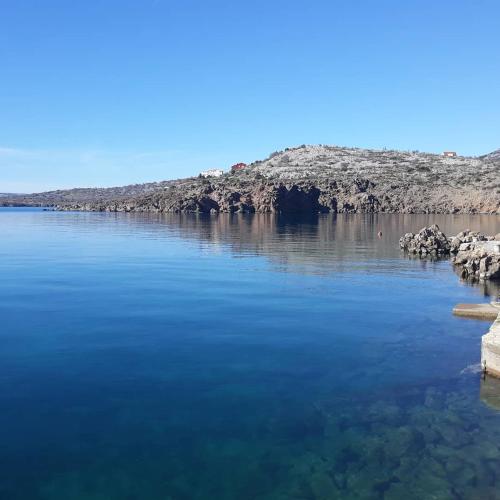 a large body of water with rocks in the water at Apartman Grospic in Cesarica