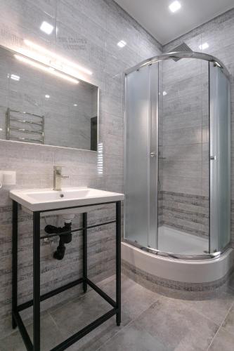 a bathroom with a sink and a shower at Motel Sun Lit in Ivano-Frankivsʼk
