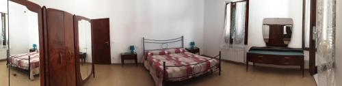 a bedroom with two beds and a mirror at Via Roma 44 in Follonica