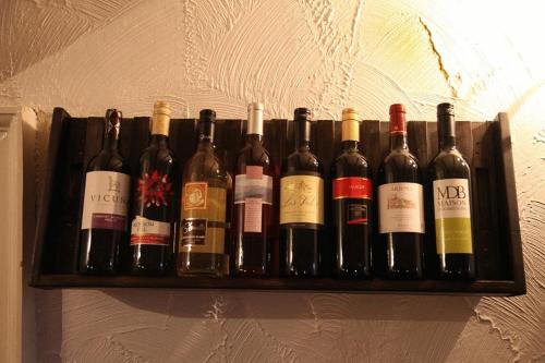 a shelf full of wine bottles on a wall at Balmoral Hotel in Moffat