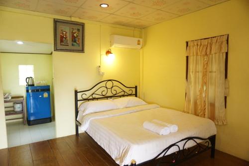 a bedroom with a bed and a television in it at Mookanda bungalow in Ko Yao Noi