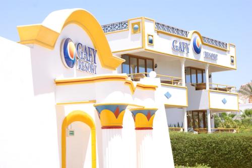 a white building with a cay sign in front of it at Gafy Resort Aqua Park in Sharm El Sheikh