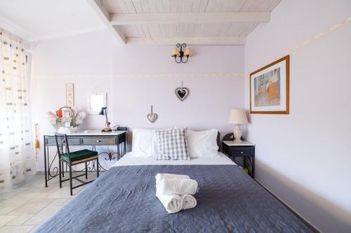 a bedroom with a bed with two towels on it at Blue Crystal Villa in Iraklitsa
