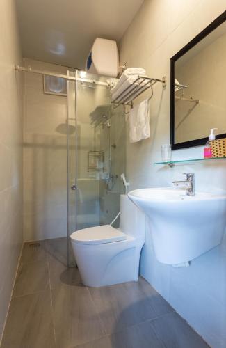 a bathroom with a toilet and a sink and a shower at Ninh Binh Palm Homestay in Ninh Binh