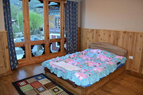 a bedroom with a bed in a room with a window at Yangkey Villa in Paro