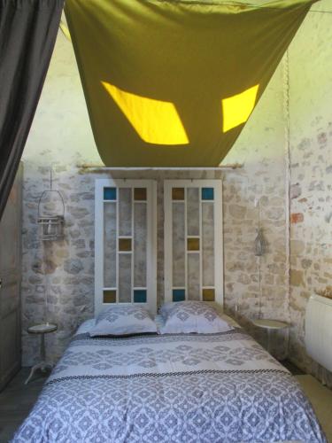 a bedroom with a bed with a canopy above it at La Maison Salée in LʼAiguillon-sur-Mer
