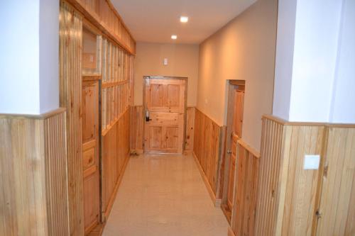 a hallway with wood paneled walls and a door at Yangkey Villa in Paro