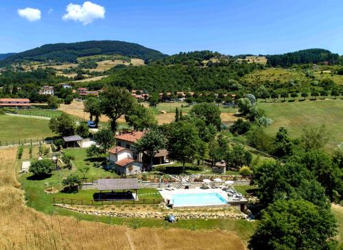 an aerial view of a farm with a swimming pool at L'Antico Cipresso in Poppi