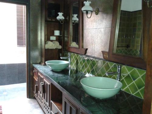 a bathroom with two sinks and two bowls on the counter at Gardenia Oceanfront Villa in Ko Chang