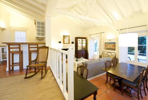 a kitchen and living room with a table and chairs at Quinta Da Cabrita in Santarém