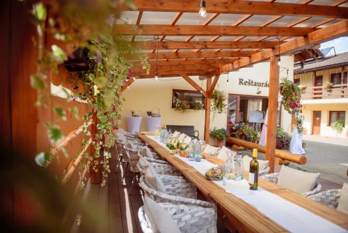a long table in a restaurant with white chairs at Turciansky dvor in Martin