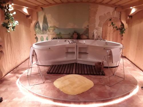 a bath tub in a room with a rug at Hotel Amselhof in Bispingen