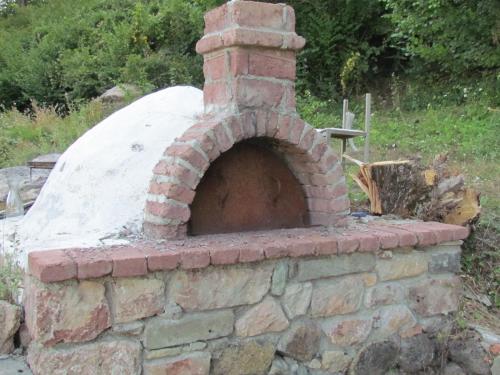 an outdoor brick oven in a yard at Hotel Germenji in Gërmenji