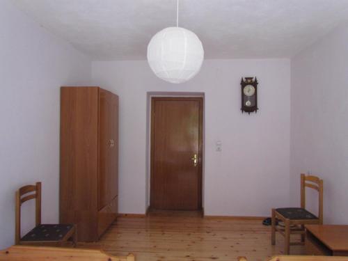 a room with a door and a clock on the wall at Hotel Germenji in Gërmenji