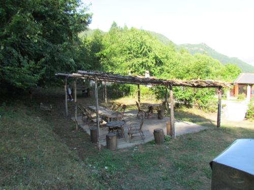 a picnic shelter with tables and chairs in a yard at Hotel Germenji in Gërmenji