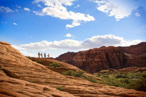a group of people standing on top of some rocks at Red Mountain Resort in St. George