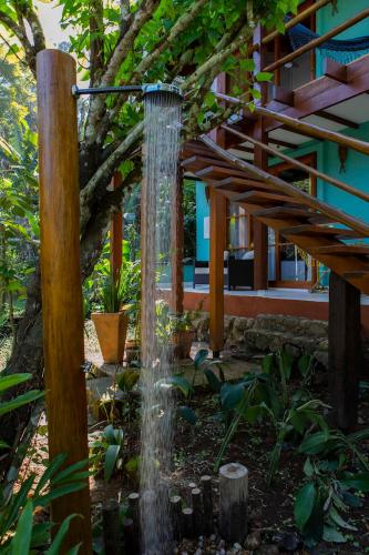a water fountain in the middle of a garden at Casa Ka in Maresias