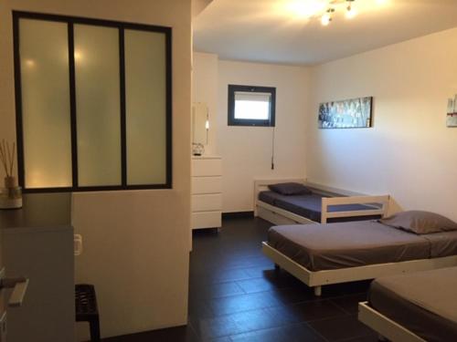 une chambre avec deux lits dans une pièce dans l'établissement Appart 8 pers vue sur baie - Porticcio, à Porticcio