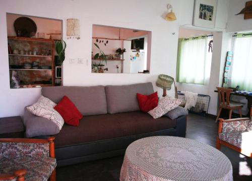 a living room with a couch and a table at Sea View Urban Oasis in Tel Aviv