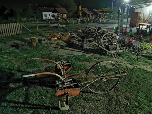 a group of old carts sitting in the grass at Etno selo EDEN in Žeravački Potok