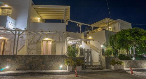 a white building with a staircase in front at night at Cyclades Studios in Parikia