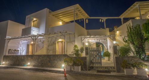 a white building with a gate in front of it at night at Cyclades Studios in Parikia