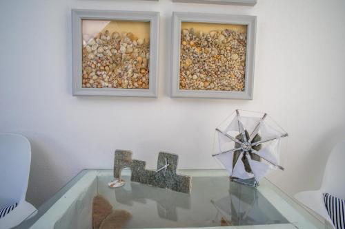 a glass table with a number in front of two pictures at Cyclades Studios in Parikia
