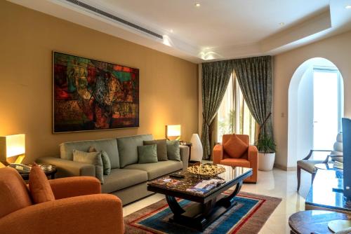 a living room with a couch and a table at Vivienda Hotel Villas in Riyadh