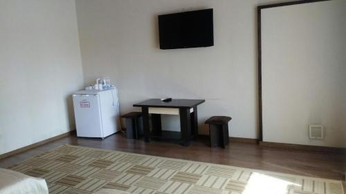 a room with a small table and a small refrigerator at versal in Ternopilʼ