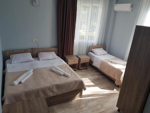 Kakhaberi的住宿－Femily hotel ın batumı maretı str 2，一间卧室设有两张床和窗户。