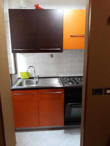 a kitchen with a sink and a stove at Etnico in Cesano Boscone