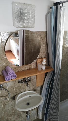 a bathroom with a sink and a mirror at Apartments Kupine in Bol