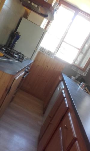 an overhead view of a kitchen with wooden cabinets at Chalet Lisa - 10 PERSONNES - PISTE 5MN EN VOITURE in Agnières-en-Dévoluy