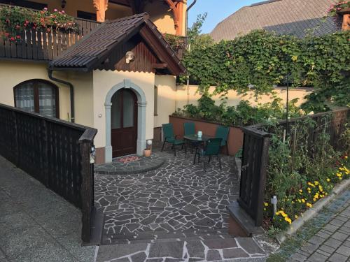 a patio with a table and chairs in front of a house at Bled Home in Bled