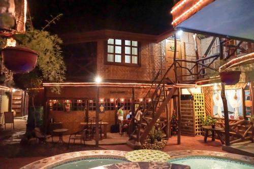 a pool in front of a building at night at Natura Vista in Panglao