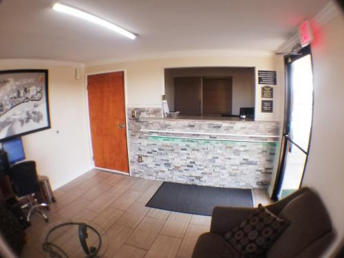 a view of a room with a kitchen and a bar at Super 8 by Wyndham McGehee in McGehee