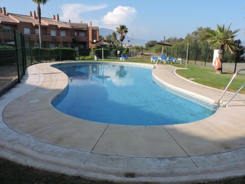 a large swimming pool with a path around it at Urbanización Manilva Beach 21 in Manilva