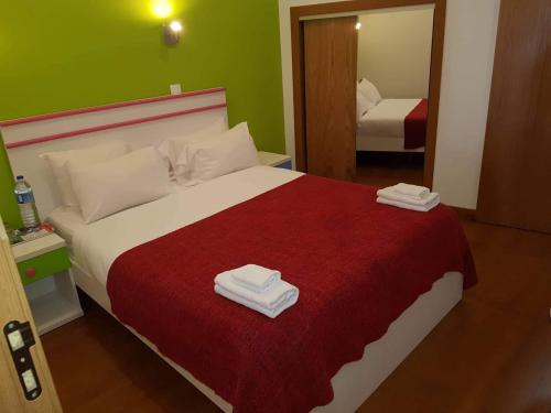 
a hotel room with a bed, desk, and lamp at Martim Moniz 28 Guest House in Lisbon
