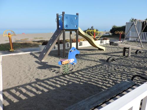 a playground with a slide on the beach at Urbanización Manilva Beach 21 in Manilva