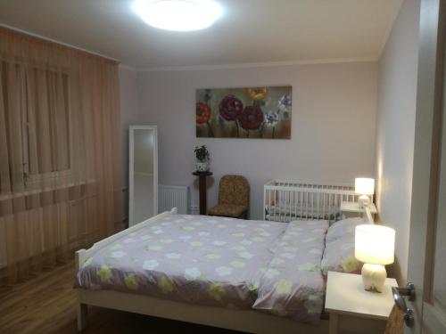 a bedroom with a bed and a table with two lamps at Comfort and convenience in Rīga