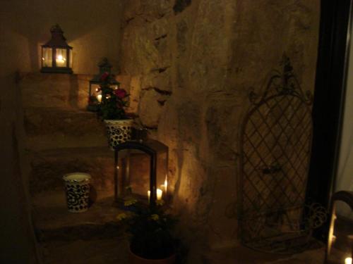 a room with a stone wall with a door and lights at Carmen De Arnas in Colungo