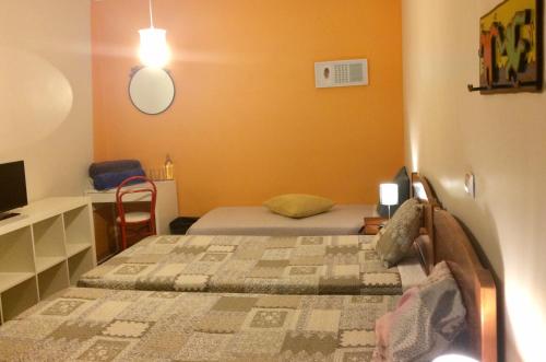 a small bedroom with two beds and a desk at Templar Secrets House in Tomar