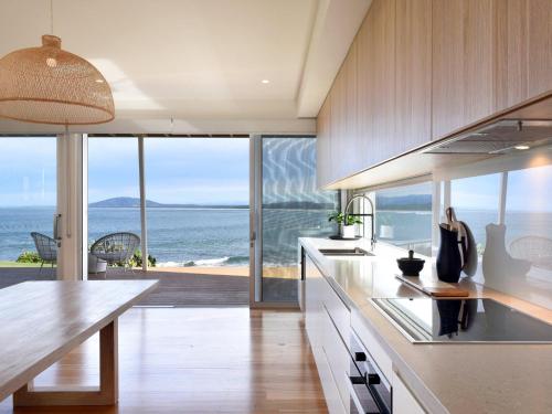 a kitchen with a view of the ocean at Absolute Waterfront in Gerroa