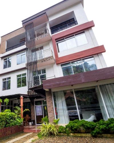 an apartment building with windows and a balcony at El Nido Royal Palm Inn in El Nido