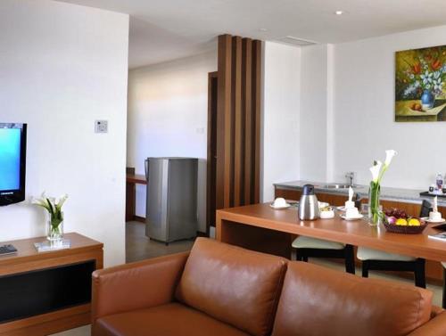 a living room with a couch and a table at Gloria Swiss Hotel & Apartment Sandakan in Sandakan