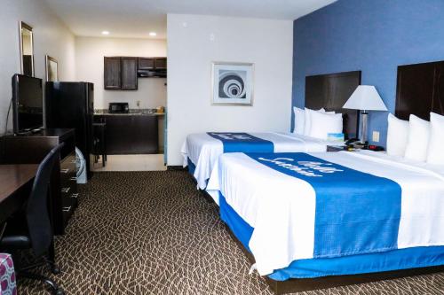 a hotel room with two beds and a kitchen at Econo Lodge in Bryan