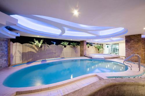 a swimming pool in a house with a ceiling at The Pinnacle Hotel and Suites in Davao City