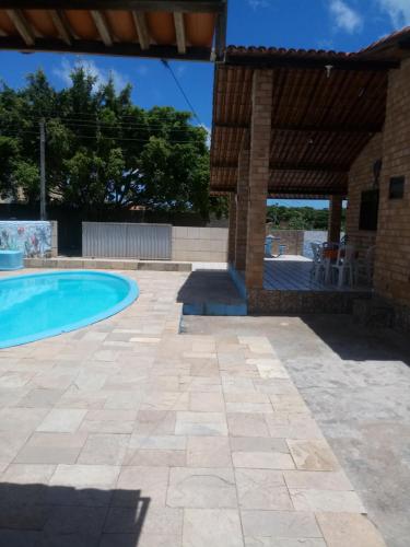 a patio with a swimming pool and a pavilion at Casa Praia de Carapibus 70m da beira mar Conde João Pessoa PB in Jacumã