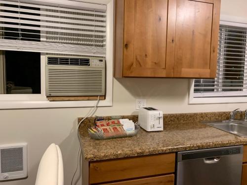 a kitchen with a counter with a sink and a microwave at The Diamond at Kingston East in Rexburg
