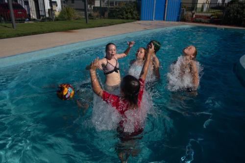 a group of people playing in a swimming pool at BIG4 Apollo Bay Pisces Holiday Park in Apollo Bay